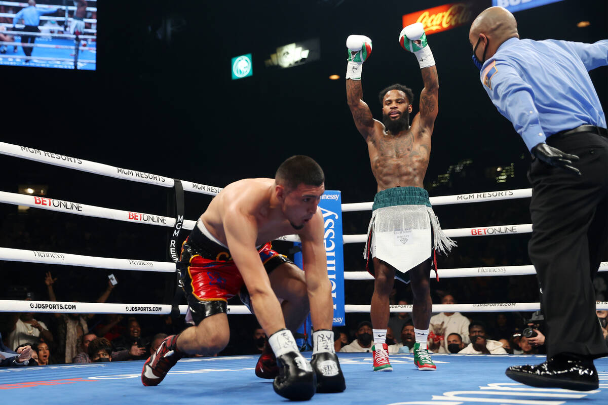 Montana Love, right, raises his arms after knocking down Carlos Diaz in second round of a super ...