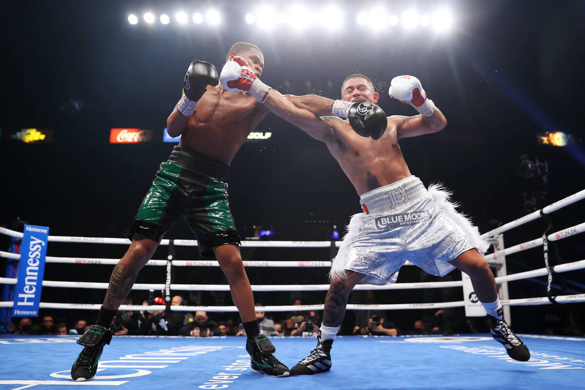 Devin Haney, left, connects a punch against Joseph Diaz Jr., in the fourth round of a WBC light ...