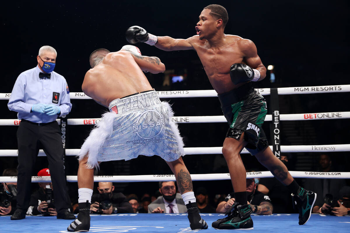 Devin Haney, right, throws a punch against Joseph Diaz Jr., in the third round of a WBC lightwe ...
