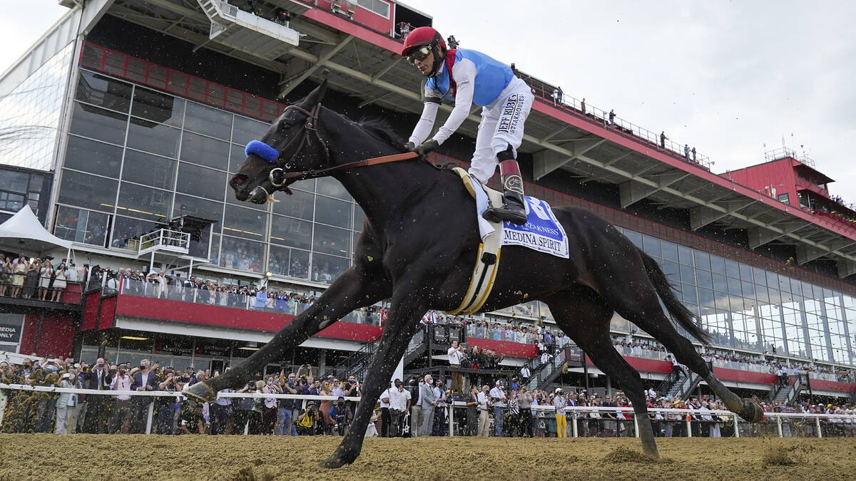 John Velazquez atop Medina Spirit competes during the 146th Preakness Stakes horse race at Piml ...