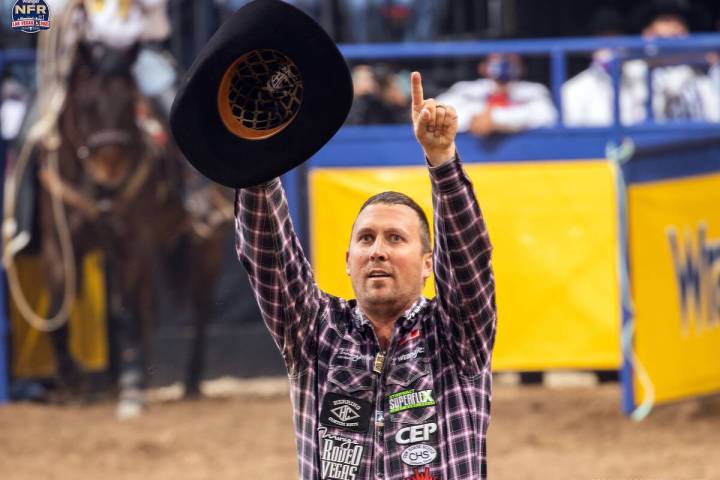 Steer wrestler Riley Duvall of Checotah, Okla., points to childhood cancer patient Emery Balch ...