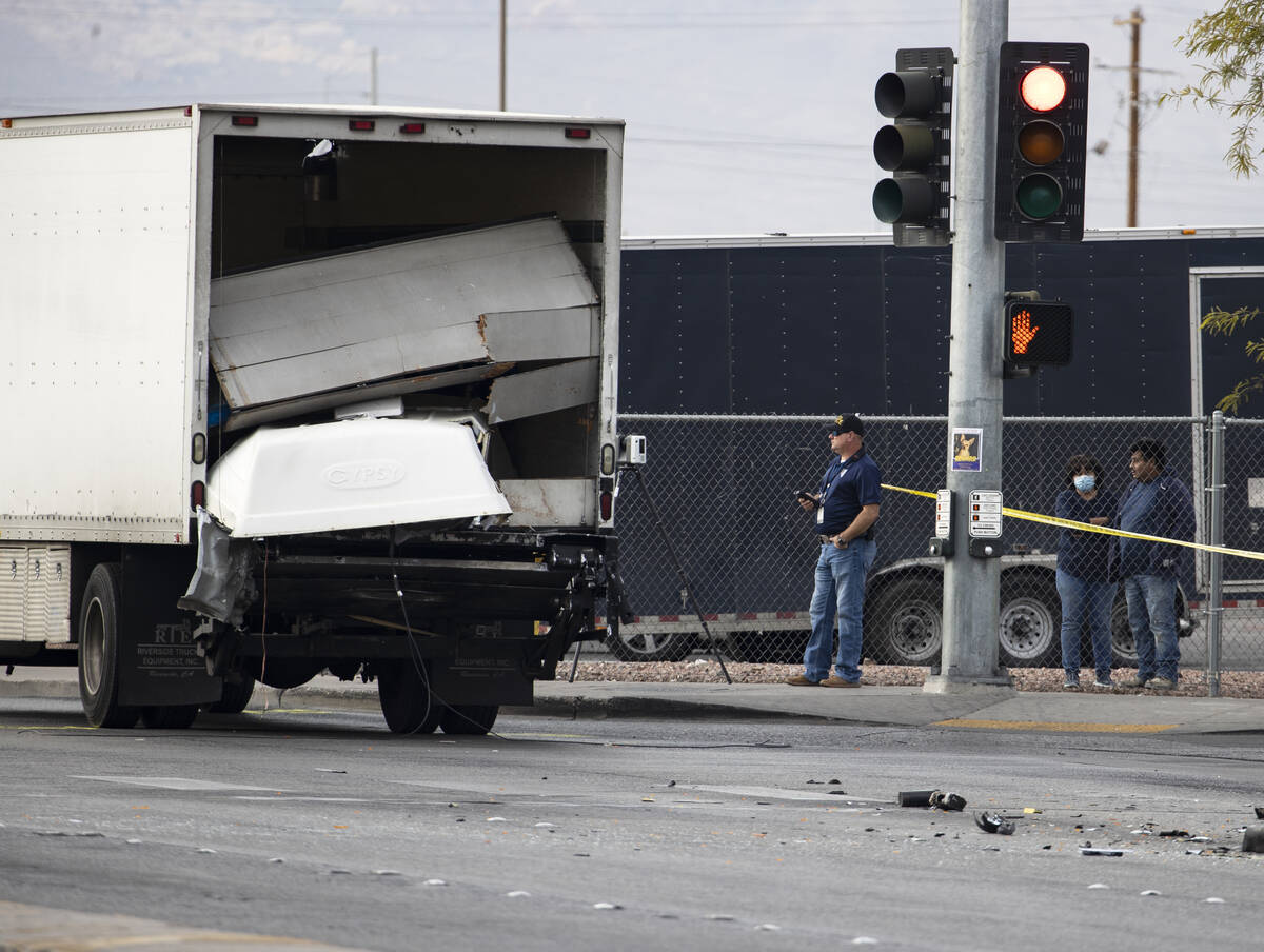 Las Vegas Metropolitan police investigate a fatal crash involving a box truck and a van at the ...