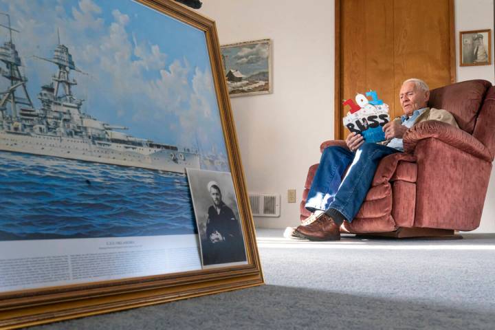 Pearl Harbor survivor and World War II Navy veteran David Russell, 101, reads a birthday card w ...