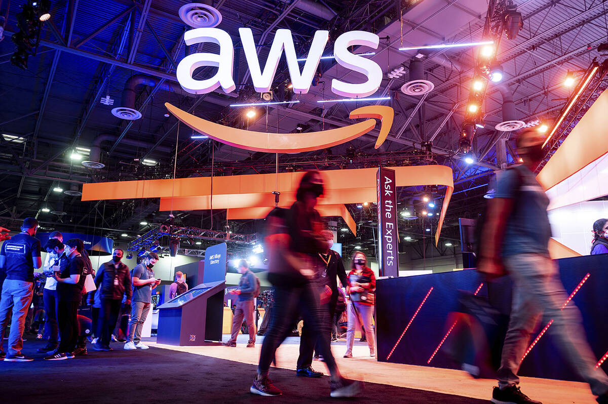 Attendees walk through an expo hall at AWS re:Invent 2021, a conference hosted by Amazon Web Se ...