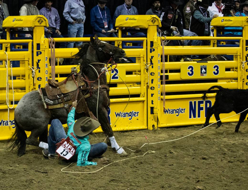 Shad Mayfield of Clovis, N.M., fell from his horse in Tie-Down Roping during the sixth round of ...