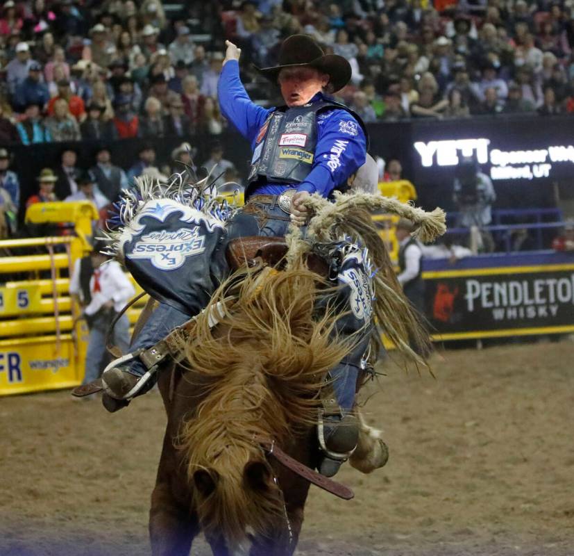 Spencer Wright of Milford, Utah competes in the saddle bronc riding event during the seventh go ...