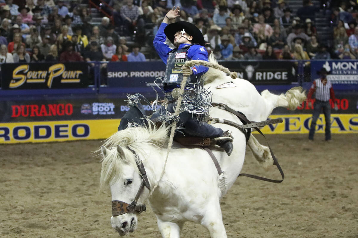 Stetson Dell Wright of Milford, Utah competes in the saddle bronc riding event during the seven ...