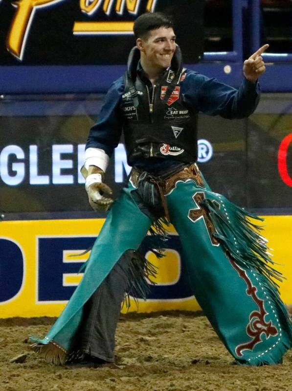 Jess Pope of Waverly, Kan. reacts after he competed in the bareback riding event during the sev ...