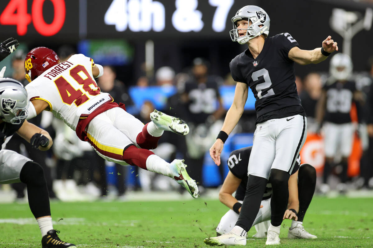 Raiders kicker Daniel Carlson (2) kicks the ball for a field goal under pressure from Washingto ...