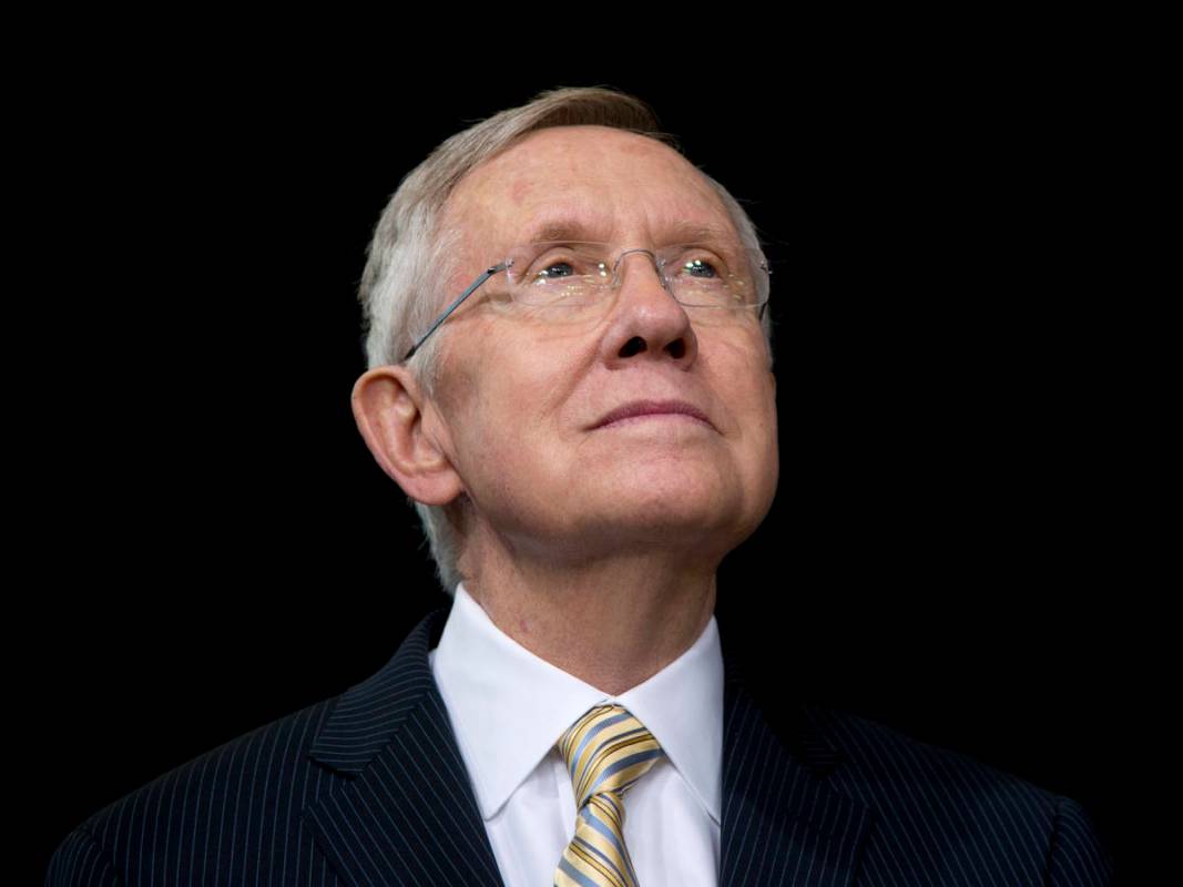 Senate Majority Leader Harry Reid of Nevada looks to President Barack Obama as he speaks about ...