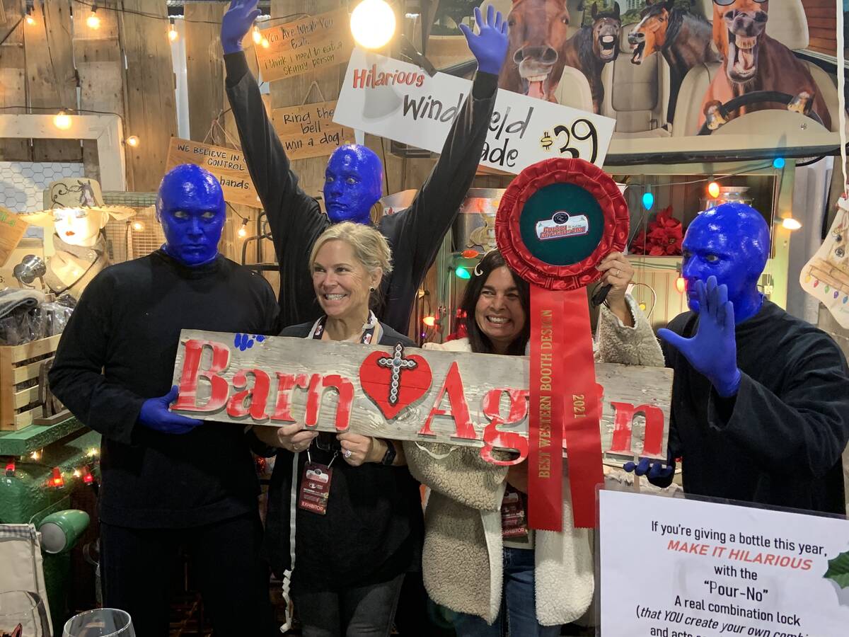 Blue Man Group poses for a celebratory photo Thursday with, from left, Renae Rosa and Helen Pet ...