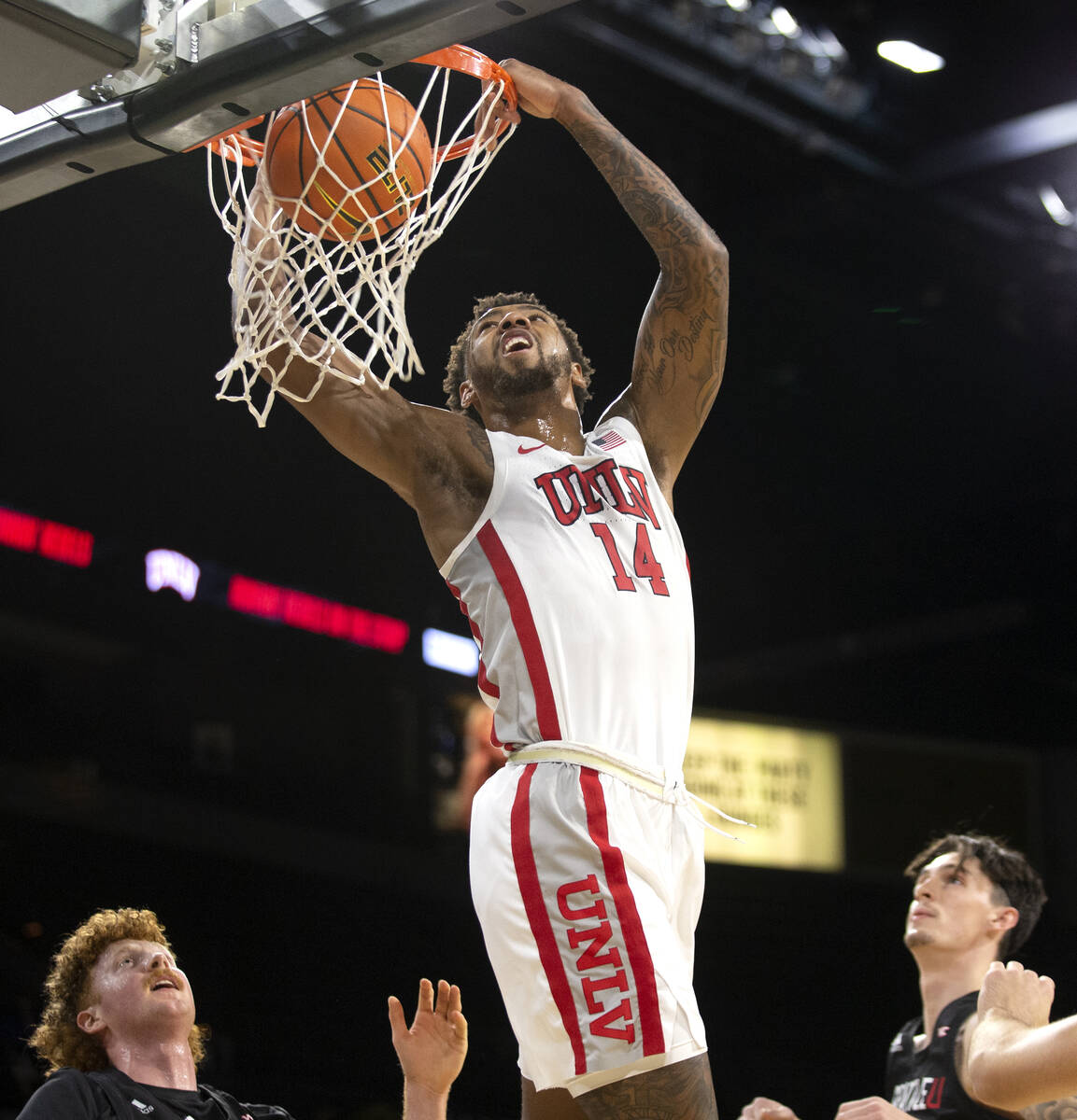 UNLV Rebels forward Royce Hamm Jr. (14) dunks while Seattle Redhawks guard Kobe Williamson (33) ...