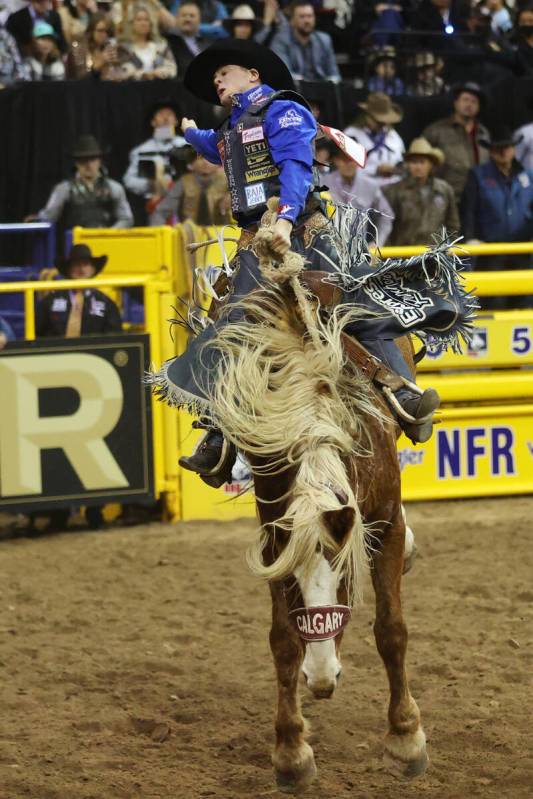 Stetson Wright of Milford, Utah, competes in the saddle bronc riding event during the ninth go- ...