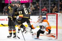 Golden Knights right wing Evgenii Dadonov (63) jumps to miss a puck shot by left wing Max Pacio ...