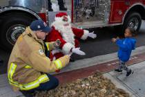 Aayden Hobbs, 3, a heart transplant recipient, runs to Santa and Chief Rick Rizzo at his home w ...