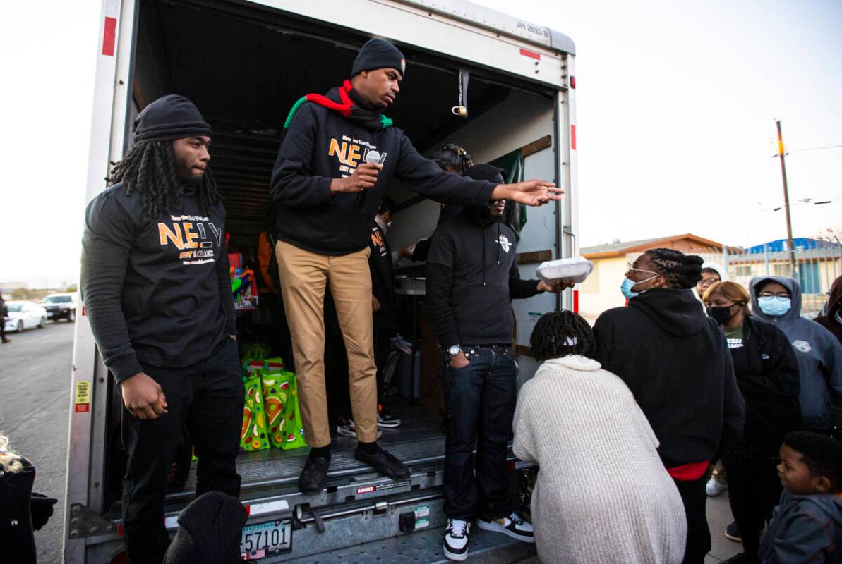 Minister Stretch Sanders, president of New Era Las Vegas, center left, helps kick off a communi ...