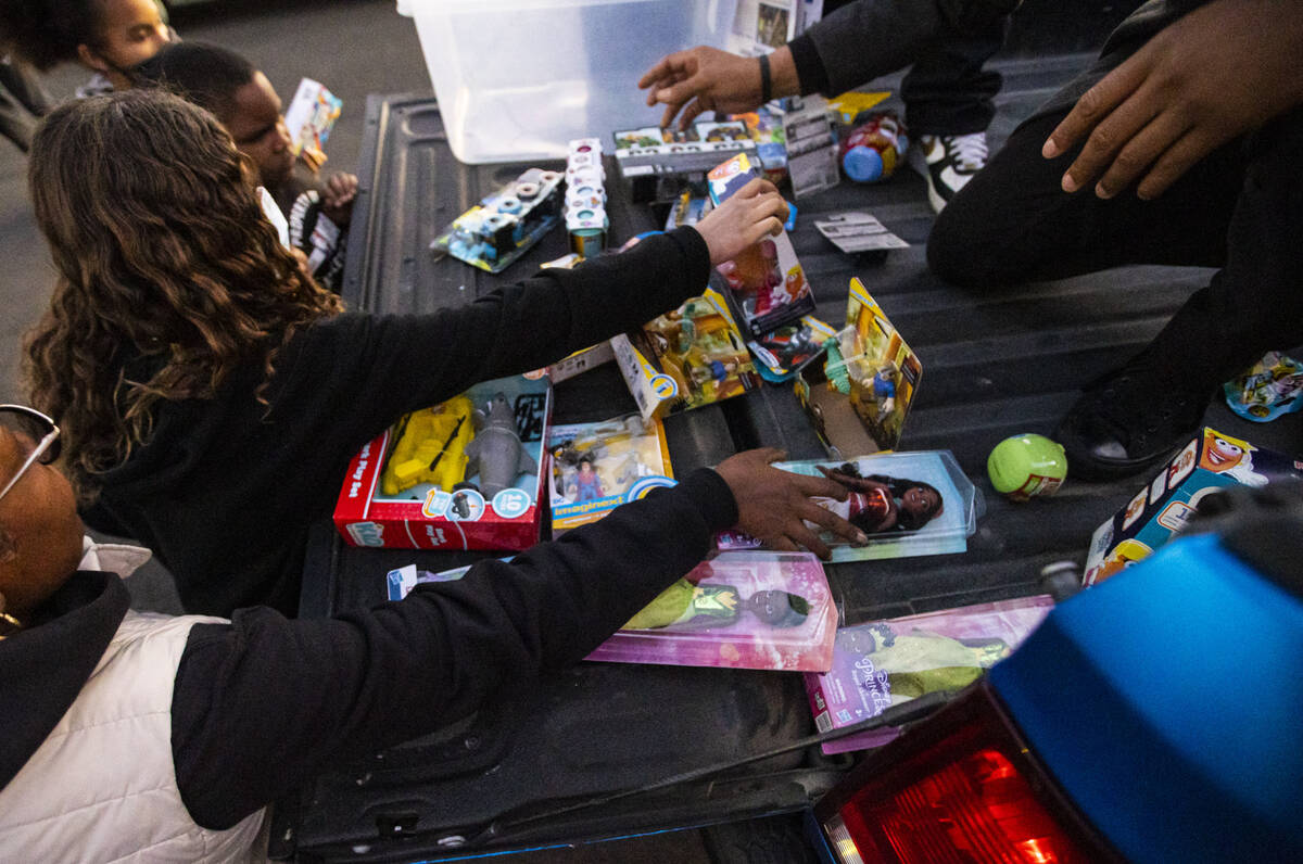 Children and parents get toys during a community event held by New Era Las Vegas and New Era Na ...