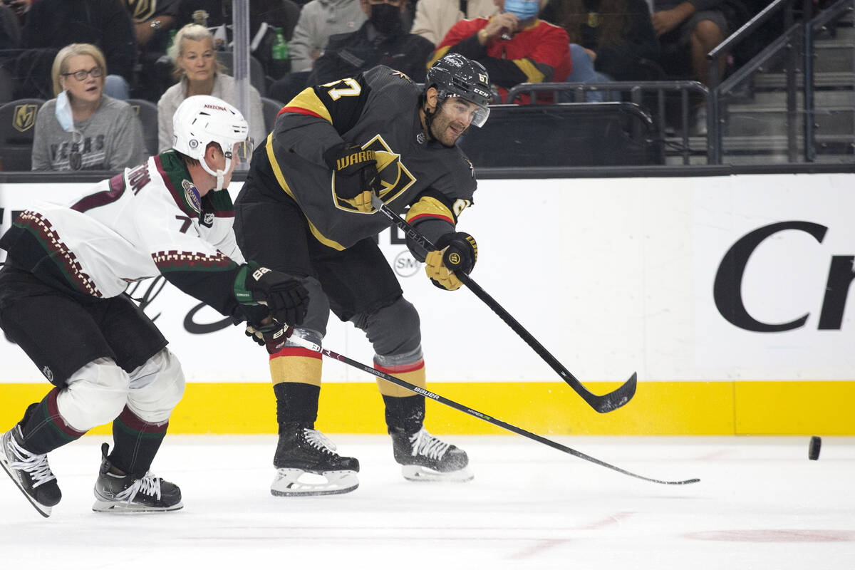 Golden Knights left wing Max Pacioretty (67) makes a shot on goal as Coyotes defenseman Victor ...