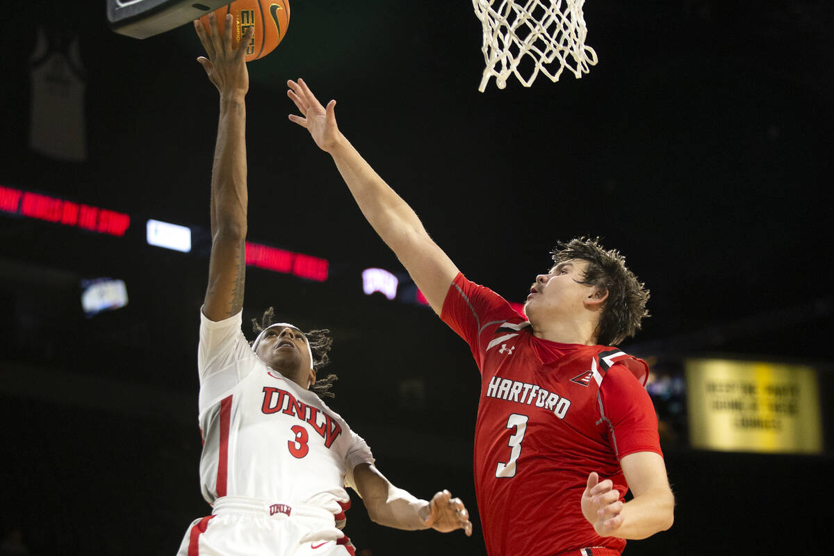 UNLV Rebels forward Donovan Williams (3) shoots against Hartford Hawks guard Romain Boxus (3) d ...