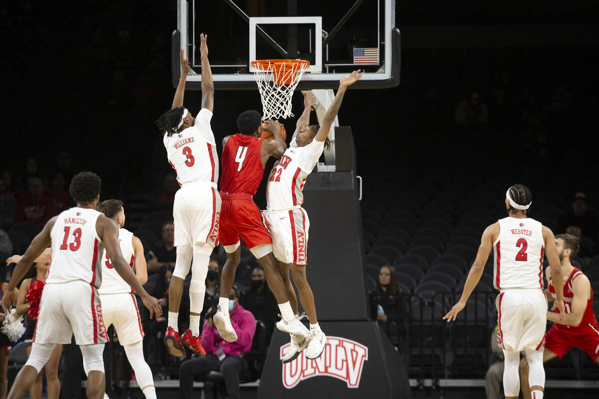 UNLV Rebels guard Josh Baker (22) and forward Donovan Williams (3) jump to block a shot by Hart ...