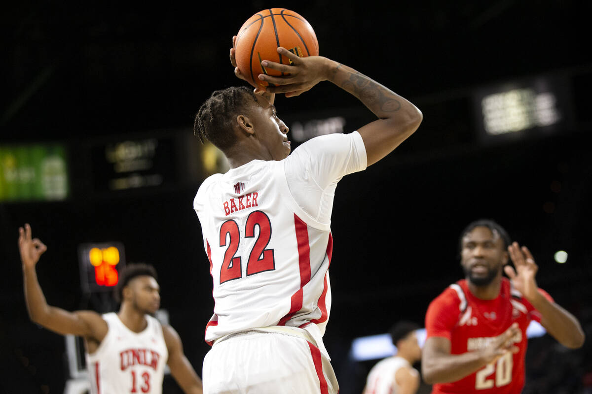 UNLV Rebels guard Josh Baker (22) attempts a three-pointer while guard Bryce Hamilton (13) hold ...