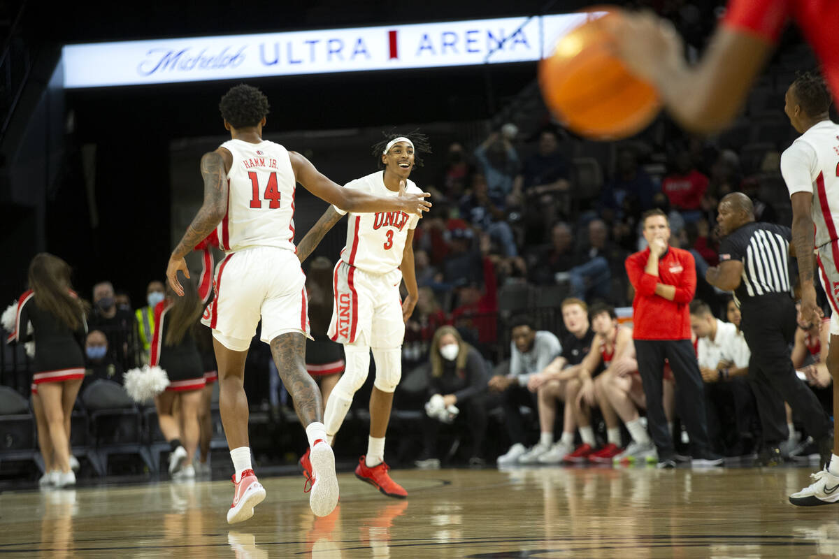 UNLV Rebels forward Donovan Williams (3) celebrates with forward Royce Hamm Jr. (14) after scor ...