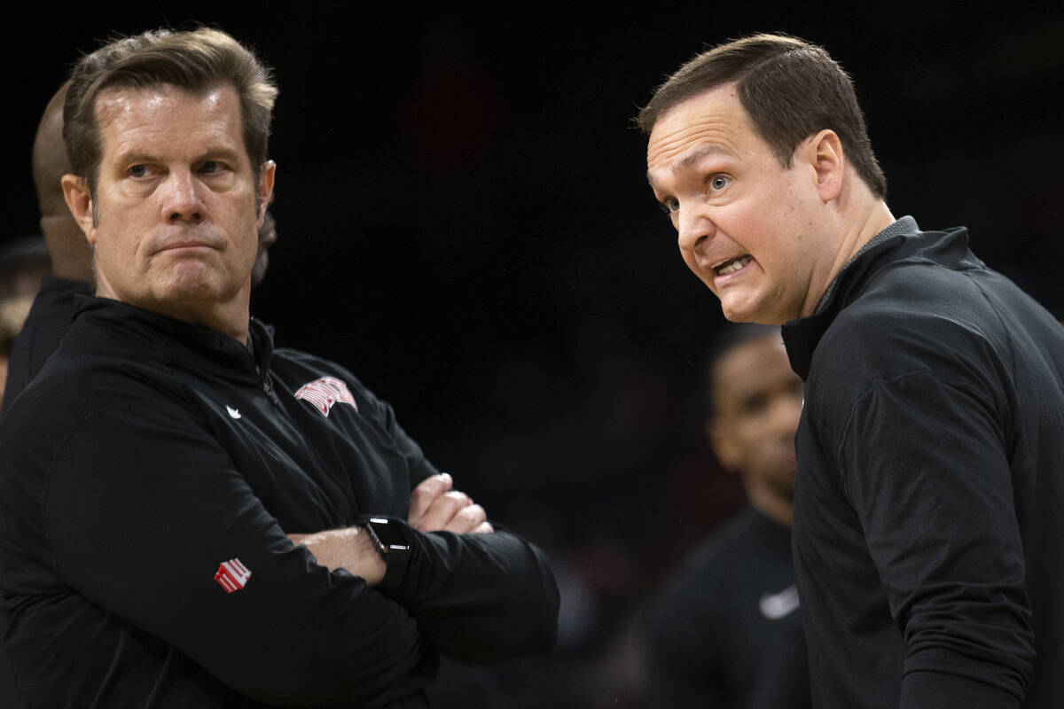 UNLV Rebels assistant coach Tim Buckley, left, and head coach Kevin Kruger speak to a referee i ...