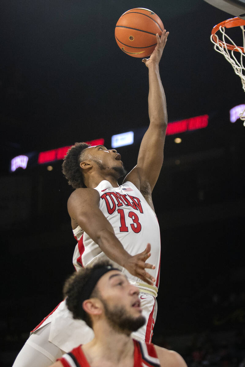 UNLV Rebels guard Bryce Hamilton (13) shoots against Hartford Hawks guard D.J. Mitchell (2) dur ...