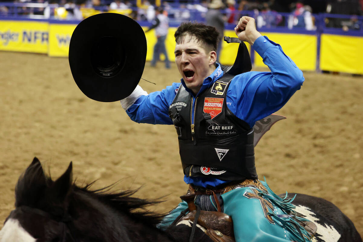 Jess Pope of Waverly, Kan., celebrates his win in the bareback riding event in the National Fin ...