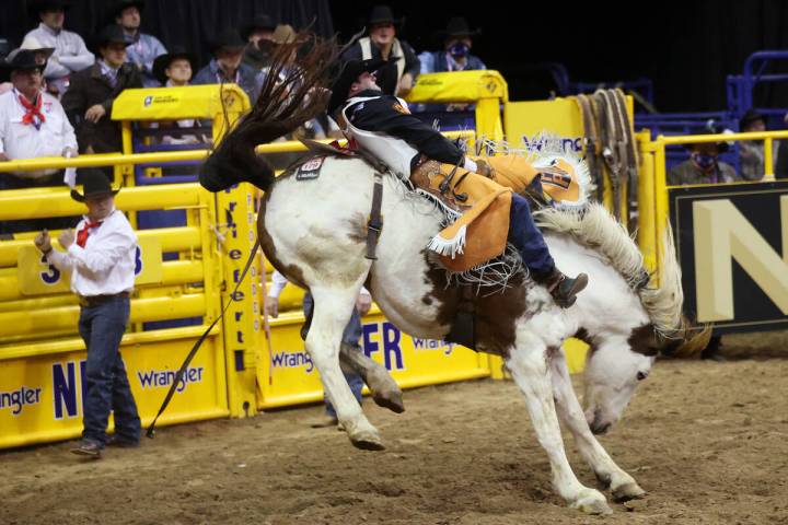 Kaycee Feild of Genola, Utah, competes in the bareback riding event during the tenth go-round o ...