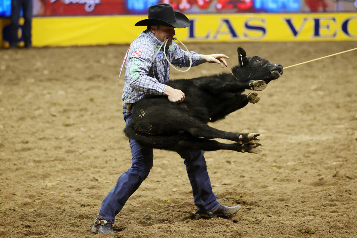 Caleb Smidt of Belville, Texas, competes in the tie-down event during the tenth go-round of the ...