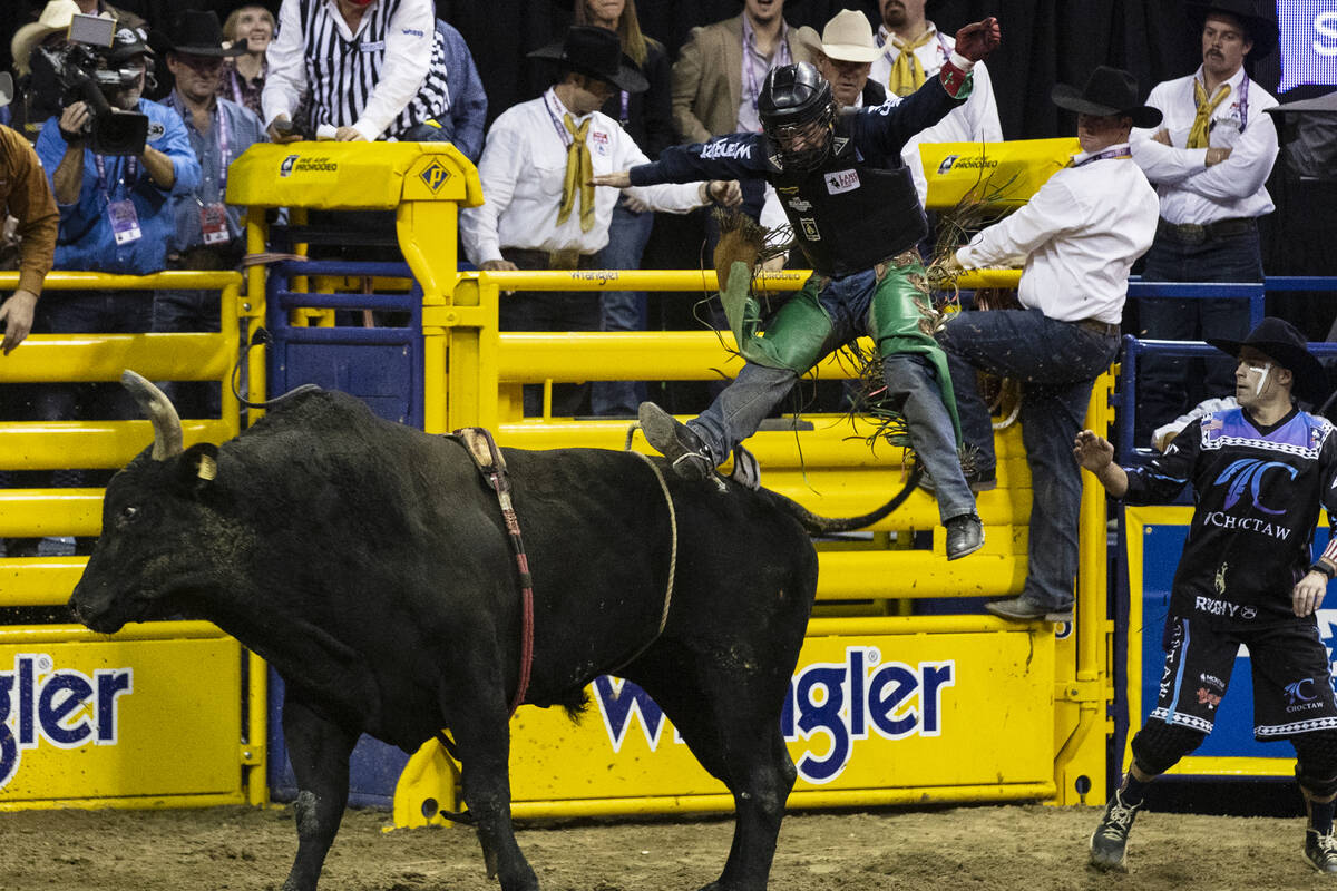 Josh Frost of Randlett, Utah, is thrown from Barracuda in bull riding during the fourth round o ...