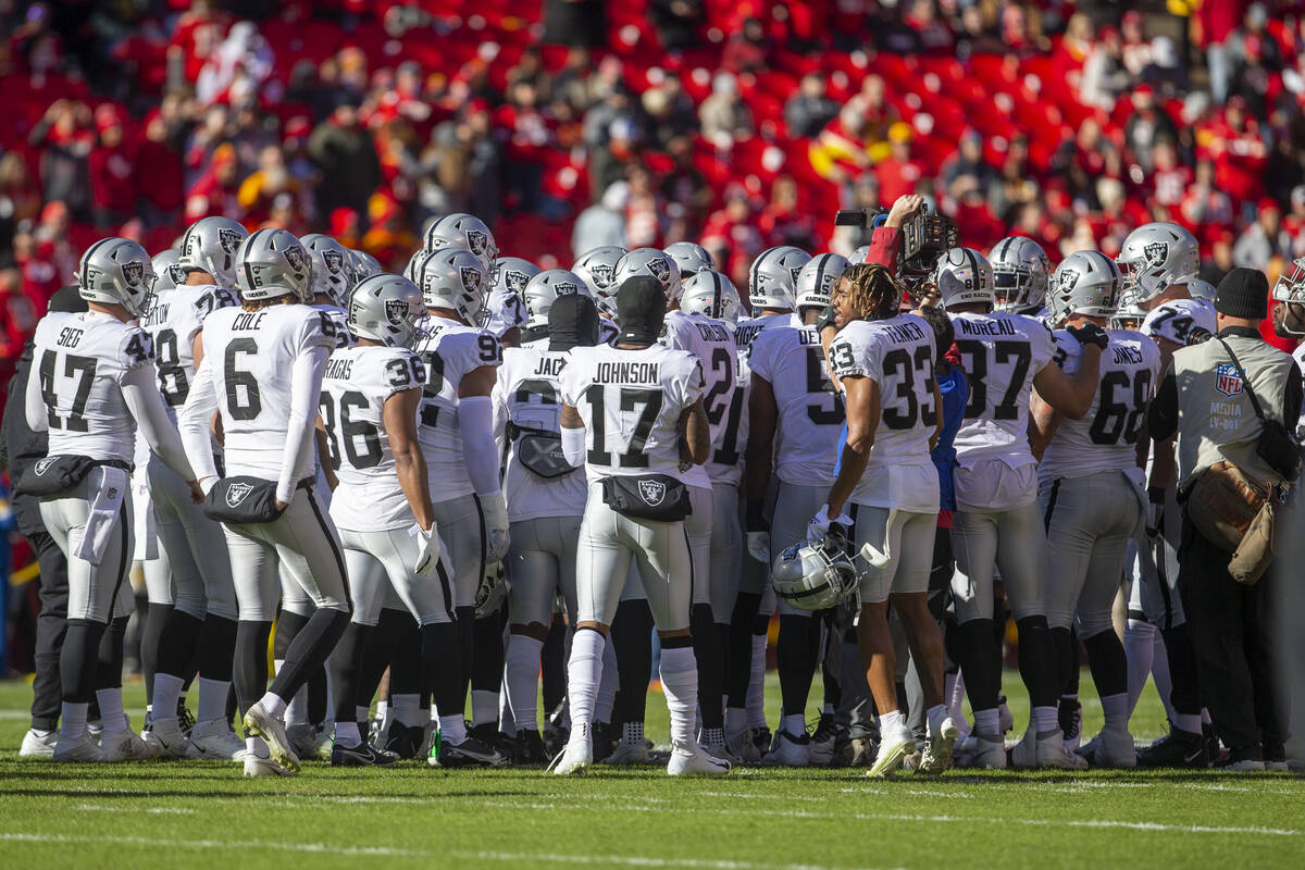 The Raiders huddle over the Kansas City Chiefs logo before an NFL football game on Sunday, Dec. ...