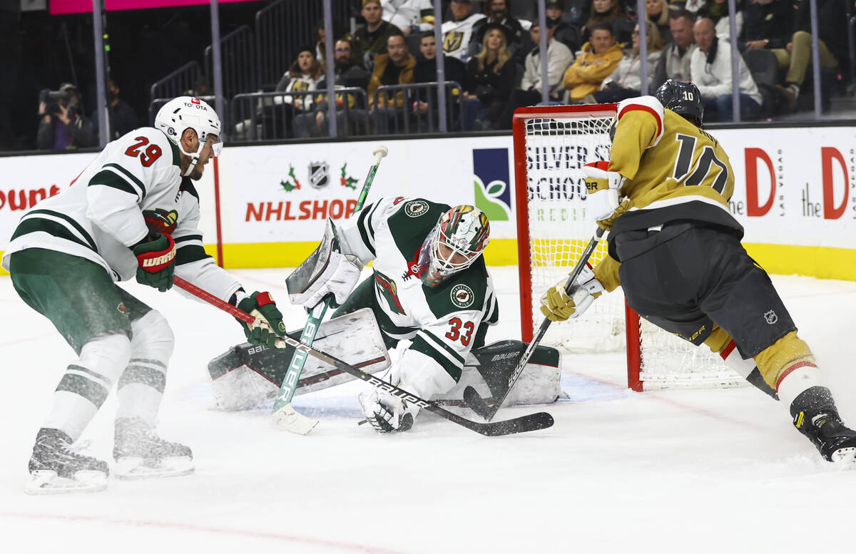 Minnesota Wild goaltender Cam Talbot (33) makes a save against Golden Knights center Nicolas Ro ...