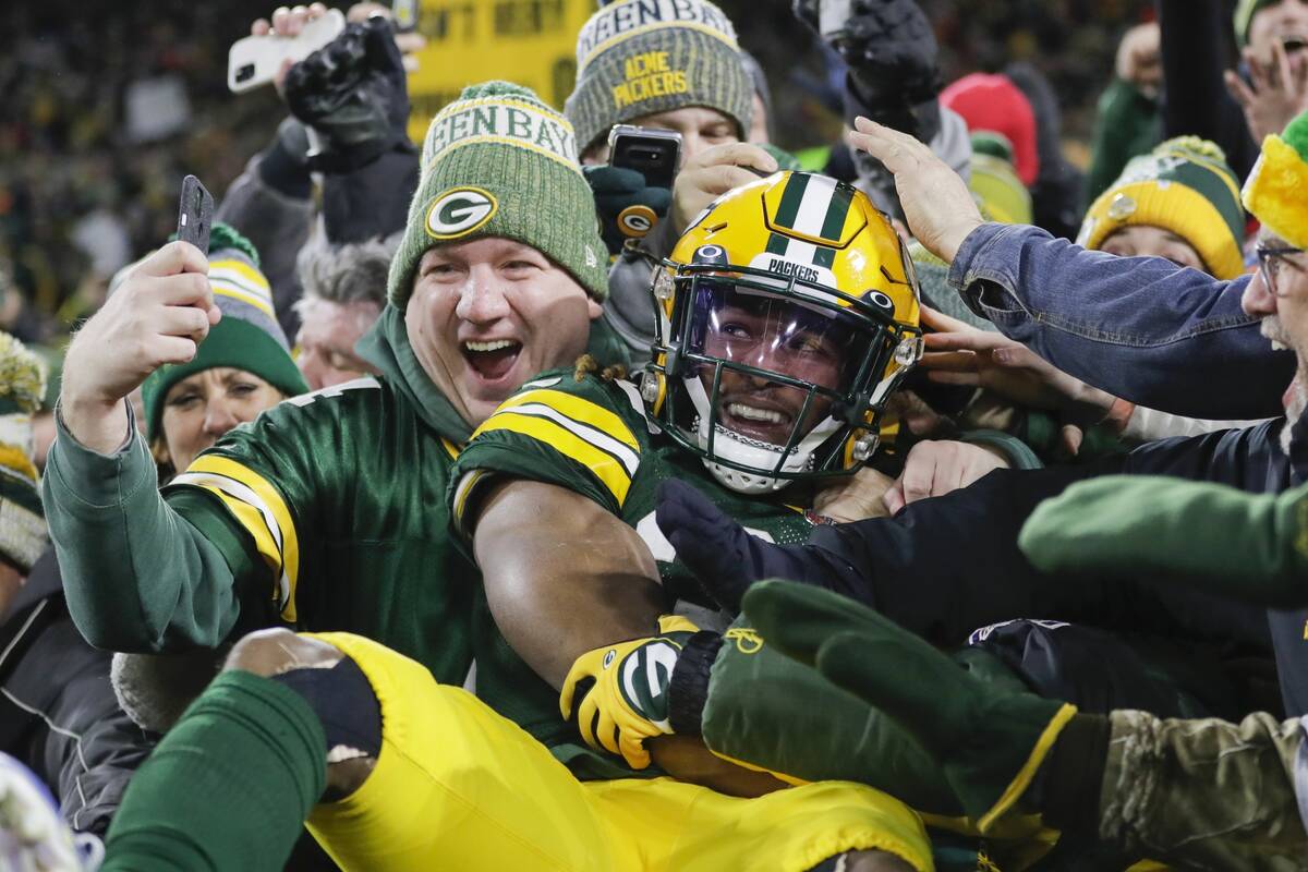 Green Bay Packers' Aaron Jones celebrates his touchdown with fans during the second half of an ...