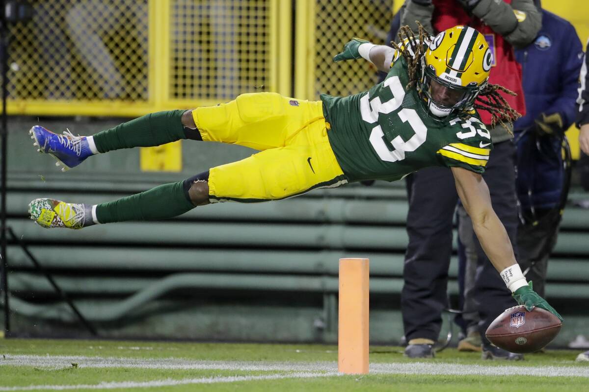Green Bay Packers' Aaron Jones dives into the end zone for a touchdown during the second half o ...