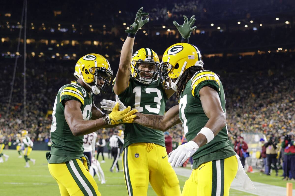 Green Bay Packers' Davante Adams celebrates his touchdown catch with Marquez Valdes-Scantling a ...