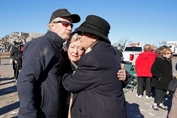 Arthur Byrn, left; Carole Dowdy, center; and Carla McDonald console each other after an outdoor ...