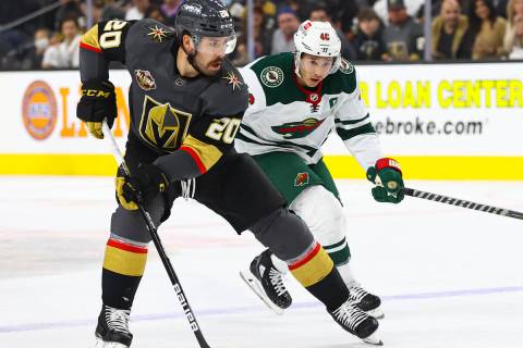 Golden Knights center Chandler Stephenson (20) skates with the puck under pressure from Minneso ...