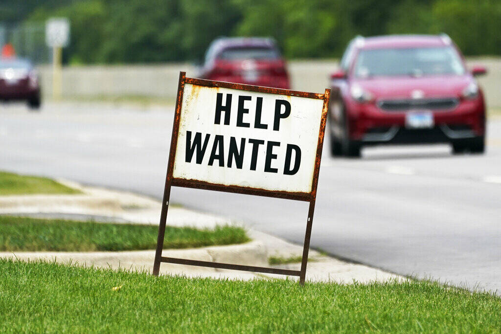 A help-wanted sign is displayed at a gas station in Mount Prospect, Ill., in July 2021. (AP Pho ...