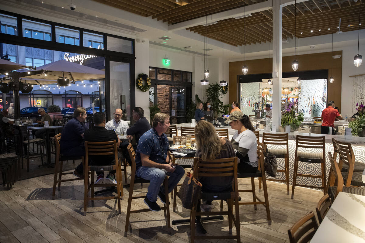 Customers enjoy happy hour at Tommy Bahama Marlin Bar & Store in Town Square Las Vegas on T ...