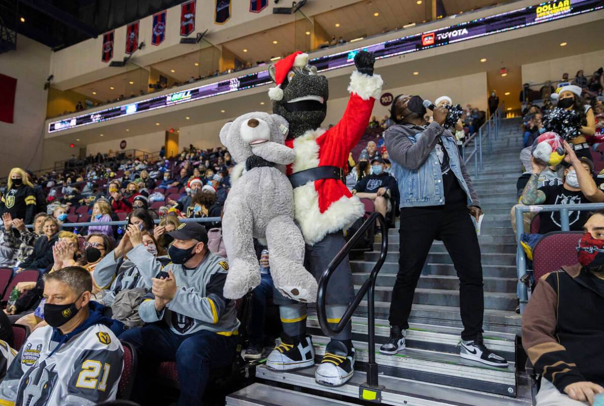 Silver Knights mascot “Lucky,” left, waits to throw a teddy bear on the ice after ...