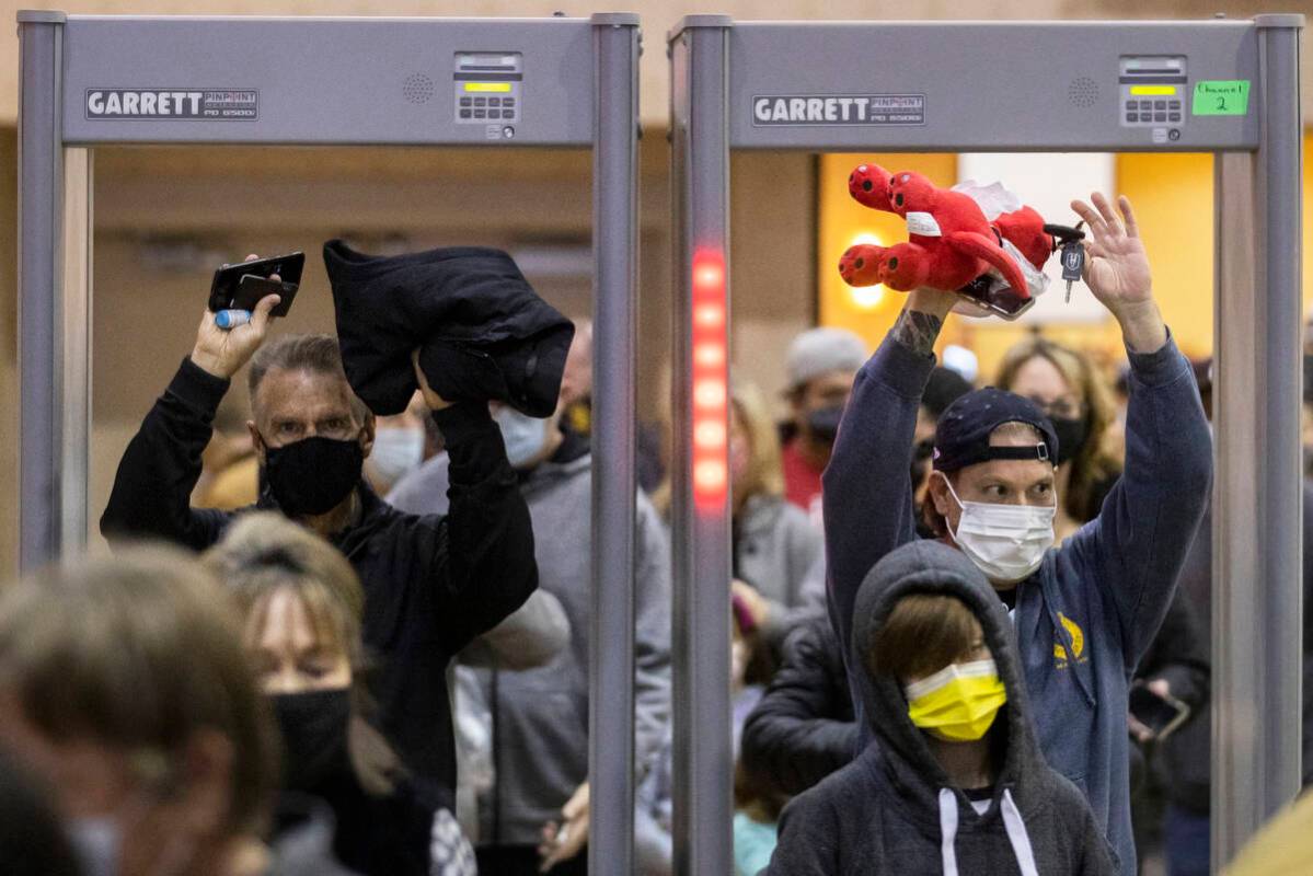 Fans bring stuffed animals through security to throw on the ice after the first Silver Knights ...