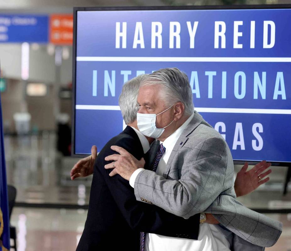 Rory Reid, son of Harry Reid, left, hugs Nevada Gov. Steve Sisolak during a ceremony renaming M ...