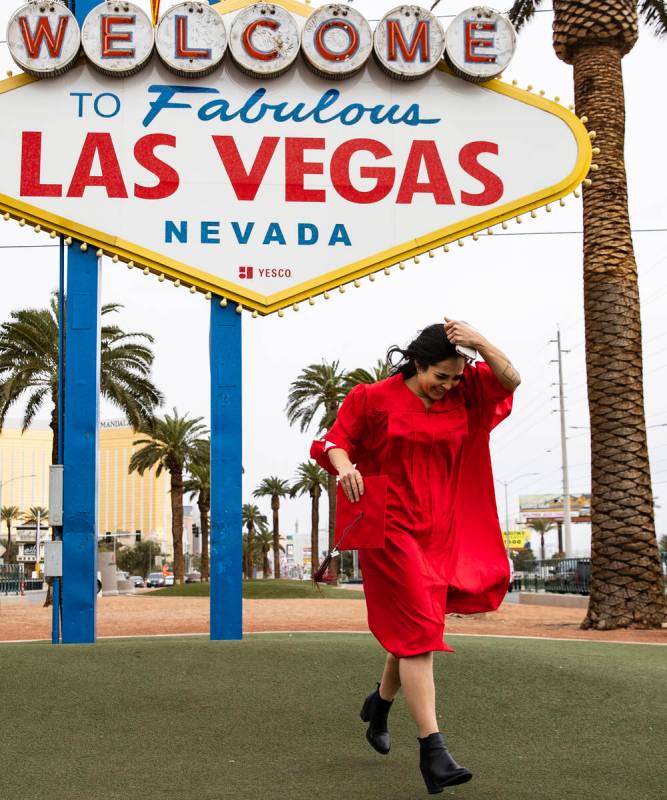Anikka Hernandez of Las Vegas, UNLV graduate, has her photo session interrupted by heavy wind a ...