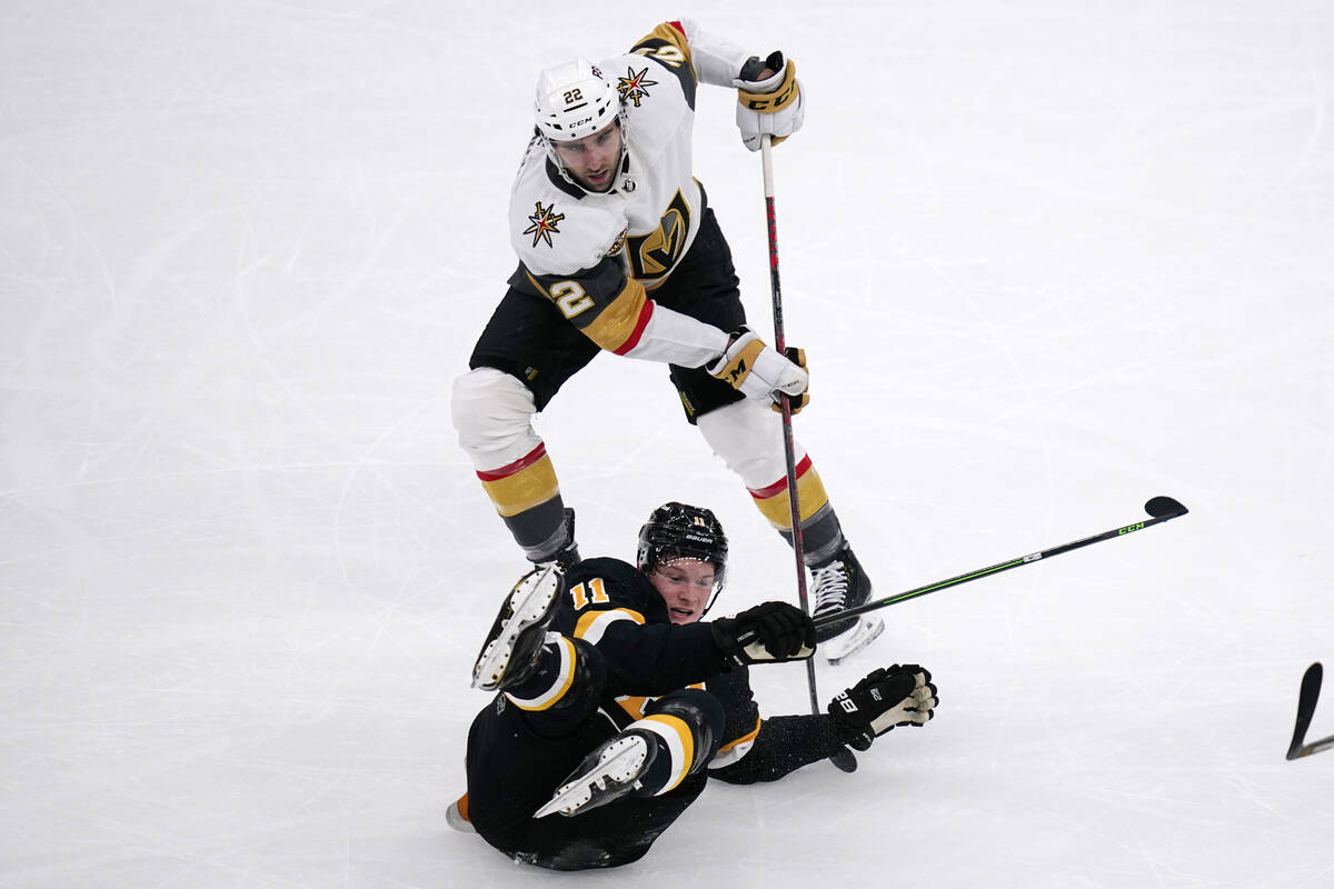 Boston Bruins center Trent Frederic (11) drops to the ice while battling Vegas Golden Knights c ...