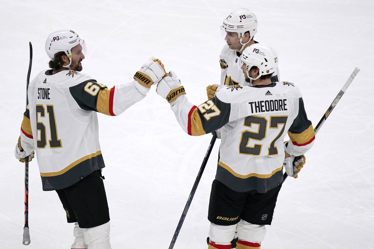 Vegas Golden Knights defenseman Shea Theodore (27) is congratulated after his goal during the f ...