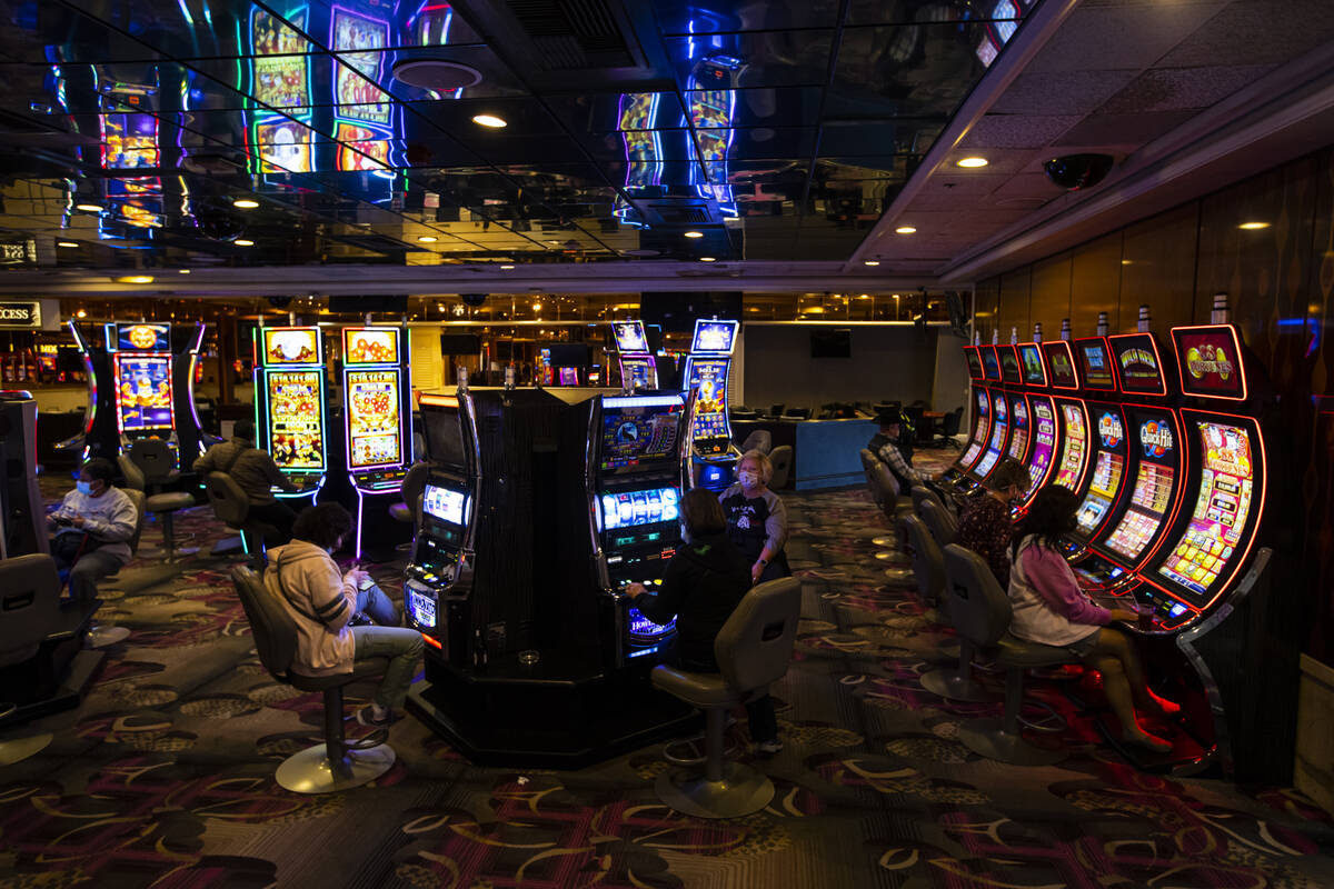 People play slot machines at the Flamingo in Las Vegas on Wednesday, Dec. 8, 2021. (Chase Steve ...