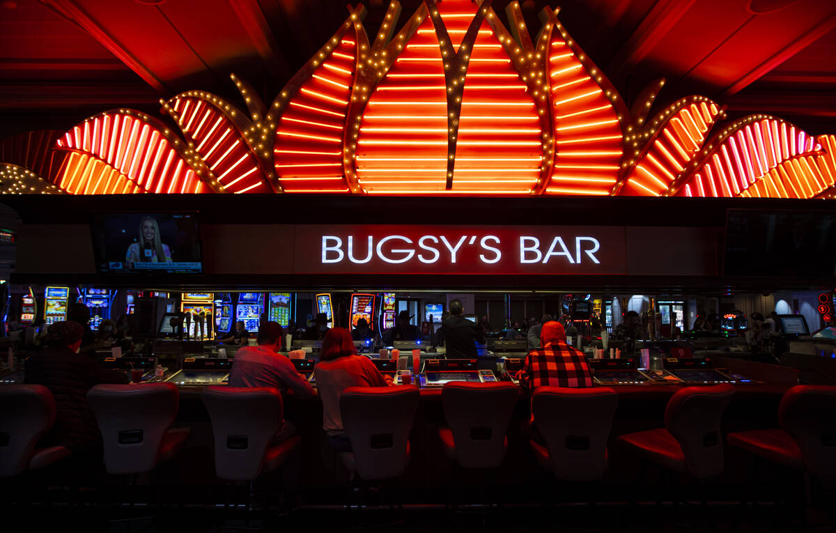 People drink and play tabletop gaming machines at BugsyÕs Bar in the Flamingo in Las Vegas ...