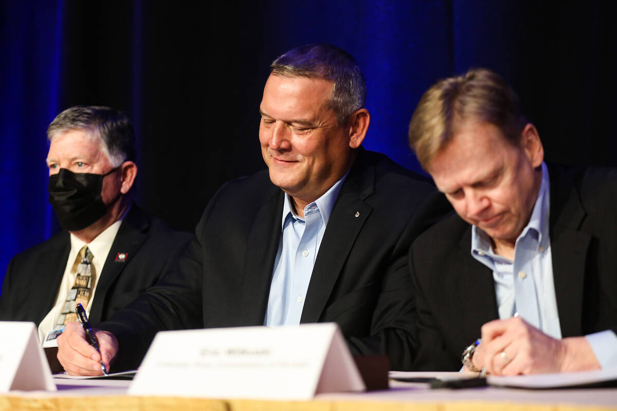 John Entsminger, president of the Southern Nevada Water Authority, center, signs an agreement c ...
